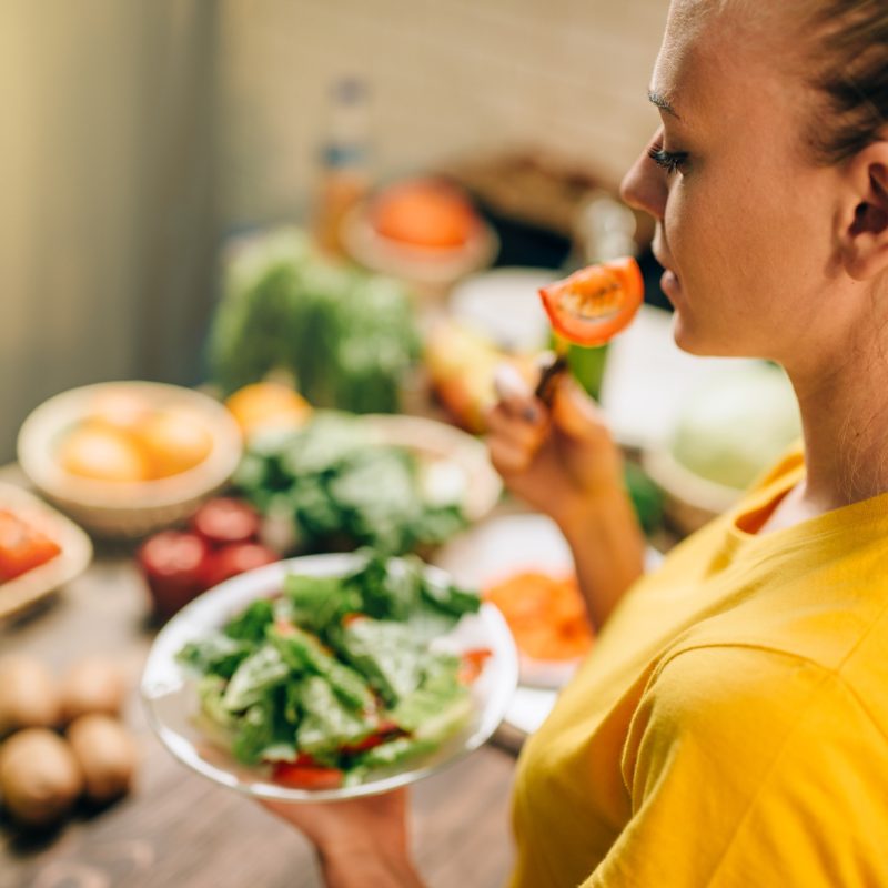 Young woman eating healthy eco food